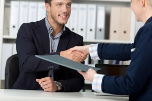 Image of an job prospect shaking hands and starting an interview